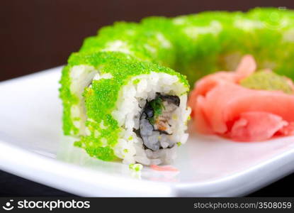 Sushi rolls made of salmon, avocado, flying fish roe - tobiko caviar and philadelphia cheese