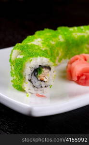 Sushi rolls made of salmon, avocado, flying fish roe - tobiko caviar and philadelphia cheese