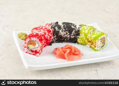 Sushi rolls made of salmon, avocado, flying fish roe - tobiko caviar and philadelphia cheese