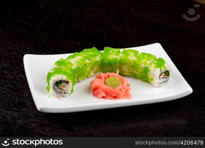 Sushi rolls made of salmon, avocado, flying fish roe - tobiko caviar and philadelphia cheese