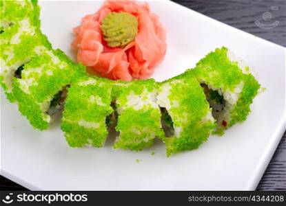 Sushi rolls made of salmon, avocado, flying fish roe - tobiko caviar and philadelphia cheese