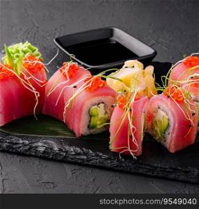 sushi rolls of red tuna on black stone
