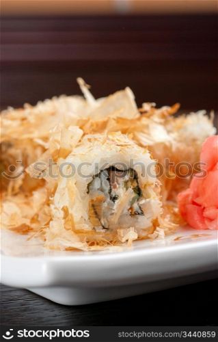Sushi rolls of rice, nori, cream cheese, avocado, smoked salmon,cucumber and cuts of tuna