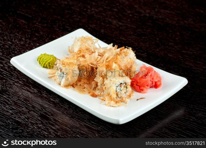 Sushi rolls of rice, nori, cream cheese, avocado, smoked salmon,cucumber and cuts of tuna