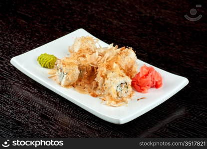 Sushi rolls of rice, nori, cream cheese, avocado, smoked salmon,cucumber and cuts of tuna