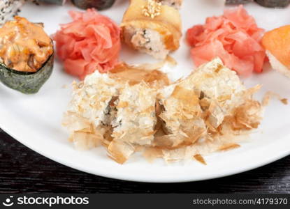 Sushi rolls of rice, nori, cream cheese, avocado, smoked salmon,cucumber and cuts of tuna