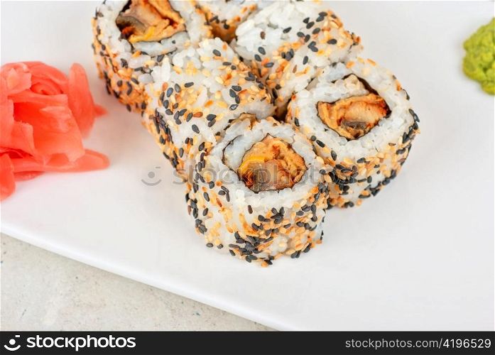 Sushi rolls of rice, omelette, eel and sesame