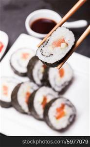 Sushi rolls on a white plate close up. Sushi rolls