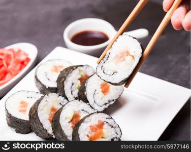 Sushi rolls on a white plate close up. Sushi rolls