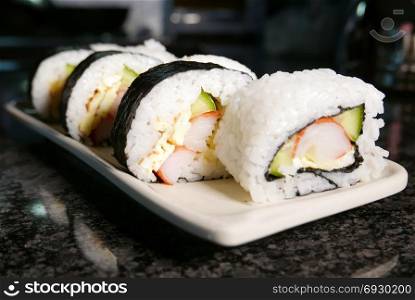 Sushi rolls on marble table