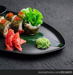 Sushi rolls served on stone slate red caviar