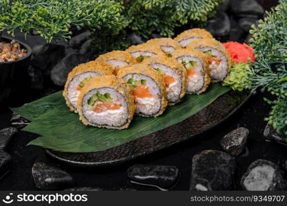 Sushi rolls tempura with salmon on plate. Japanese food style.