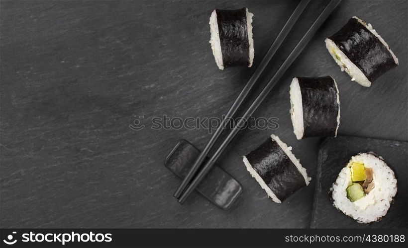 sushi rolls with chopsticks copy space