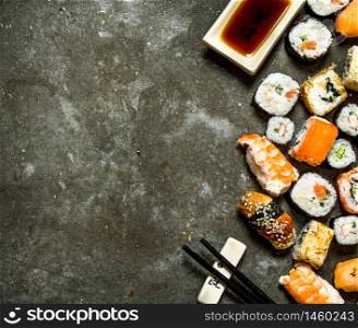 Sushi rolls with seafood and soy sauce. On the stone table.. Sushi rolls with seafood and soy sauce.