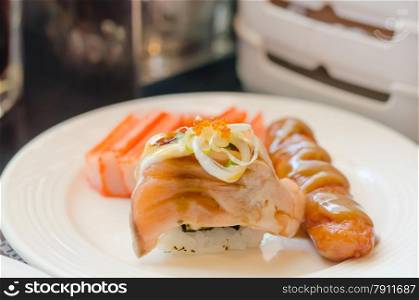 sushi. Salmon roll sushi with sausage and crab strick in white dish