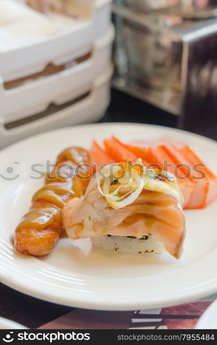 sushi. Salmon roll sushi with sausage and crab strick in white dish