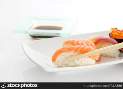 sushi with chopsticks in white background