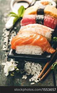 sushi with chopsticks on old wooden background, close up. sushi with chopsticks on old wooden background