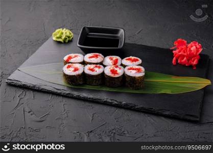 Sushi with red caviar on black stone