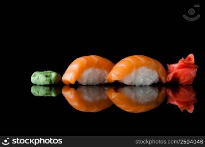 sushi with rice and wasabi on a black background with reflection. sushi on black background