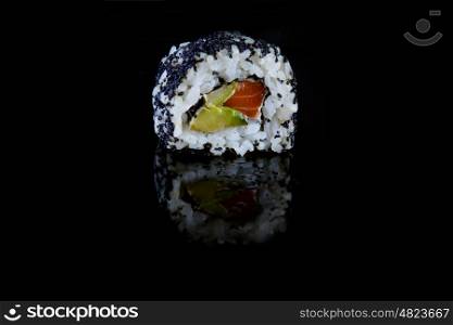 sushi with salmon and avocado on black background