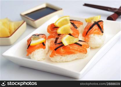 sushi with salmon and lemon on plate