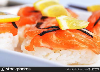 sushi with salmon and lemon on plate