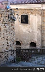 Suspended bicycle in the lane of the Old town of Veliko Tarnovo in Bulgaria