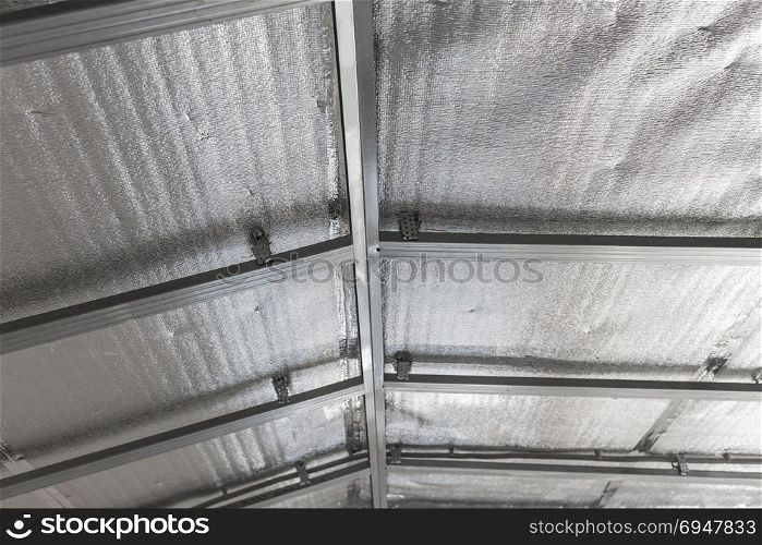 Suspended ceiling of the attic with reflective heat barrier. Suspended ceiling of the attic with reflective heat barrier.
