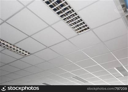 Suspended ceiling with LED square lamps sin the office close-up. Suspended ceiling with LED square lamps sin the office