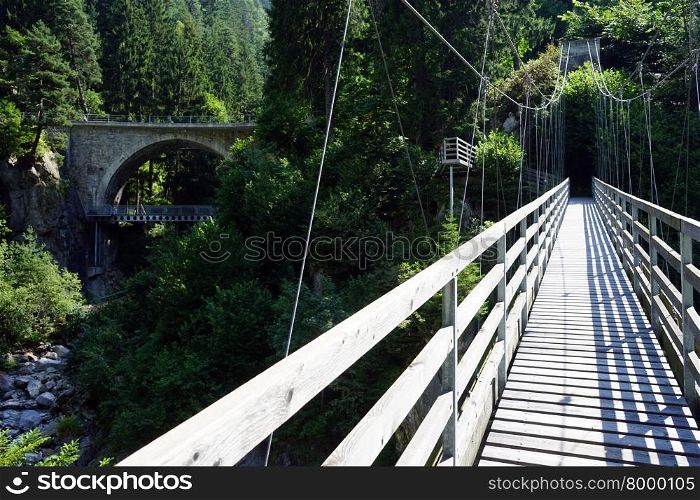 Suspension bridge and arch bridge in the forest, Switzerland