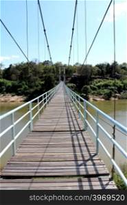 suspension bridge over river in rainforest