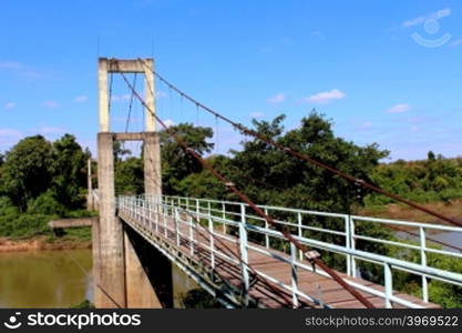 suspension bridge over river in rainforest