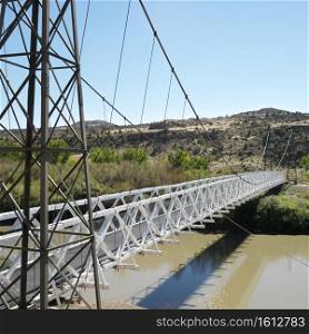 Suspension bridge over river in Utah.