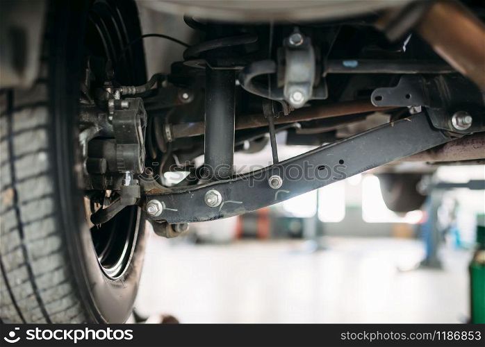 Suspension, closeup view from under the car, nobody. Automobile repair, vehicle maintenance, tire service