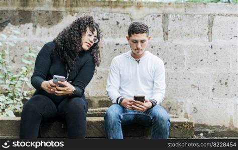 Suspicious person spying on her boyfriend phone. Jealous girl spying on her boyfriend cell phone, suspicious girlfriend spying on her boyfriend cell phone