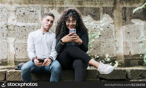 Suspicious person spying on his girlfriend phone, Jealous guy spying on his girlfriend phone, Distrustful boyfriend spying on his girlfriend phone