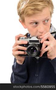 Suspicious teenage boy holding retro camera against white background