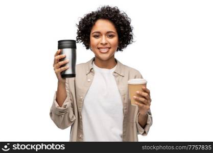 sustainability and people concept - portrait of happy smiling woman choosing between takeaway coffee cup and tumbler for hot drinks over white background. woman with coffee cup and tumbler for hot drinks