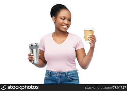 sustainability and people concept - portrait of happy smiling young african american woman with coffee cup and tumbler for hot drinks over white background. woman with coffee cup and tumbler for hot drinks
