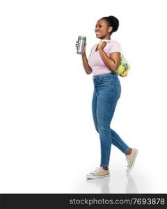 sustainability and people concept - smiling young african american woman with thermo cup for hot drinks and food in string bag walking over white background. woman with tumbler and food in string bag