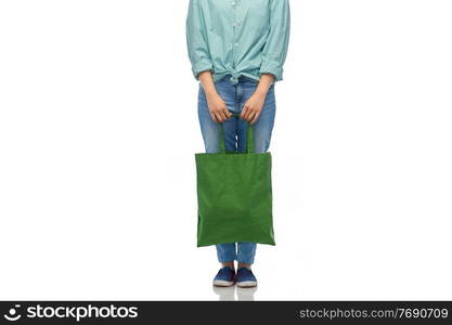 sustainability and people concept - woman in turquoise shirt and jeans with green reusable canvas bag for food shopping over white background. woman with reusable canvas bag for food shopping