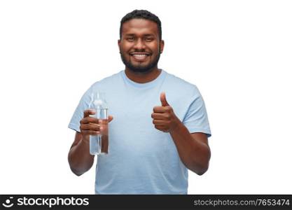 sustainability, consumerism and eco friendly concept - happy smiling african american man with water in reusable glass bottle showing thumbs up over white background. happy african man with water in glass bottle
