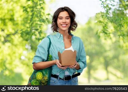 sustainability, food shopping and eco friendly concept - smiling woman holding reusable net bag with fruits and vegetables and takeaway wok box over green natural background. happy woman with food in reusable net bag and wok