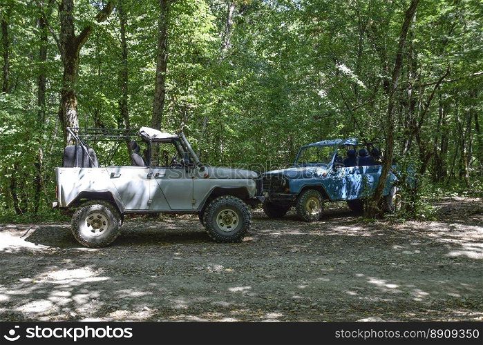 SUV in the forest. Transport for hilly and mountainous terrain. Russian off-road vehicle.. Shapsugskaya, Russia - June 30, 2017  SUV in the forest. Transport for hilly and mountainous terrain. Russian off-road vehicle.