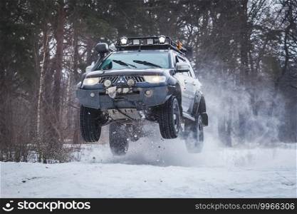 SUV jumped on the rise of snow winter forest. SUV jumped on rise of snow winter forest