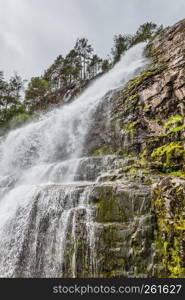 Svandalsfossen in Norway, waterfall in norwegian mountains. National tourist Ryfylke route.. Svandalsfossen in Norway, Ryfylke route