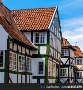 Svendborg, Denmark - 10 June, 2021  colorful whitewashed half-timbered houses under a blue sky