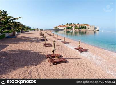 Sveti Stefan sea islet morning view with pink sandy Sveti Stefan Beach (Montenegro, 6 kilometres southeast of Budva)