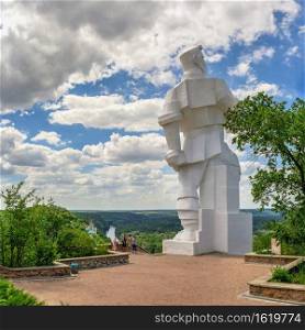 Svyatogorsk, Ukraine 07.16.2020.  Monument to Artem on the mountain above the Svyatogorsk or Sviatohirsk lavra on a sunny summer day. Monument to Artem over the Svyatogorsk Lavra in Ukraine